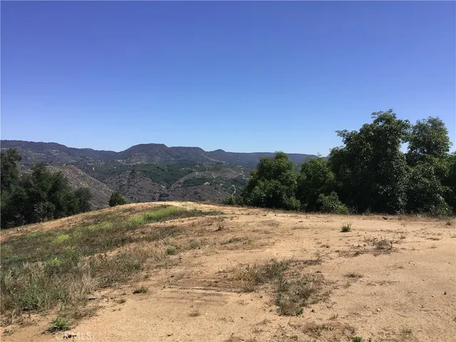 a view of a yard with a wooden fence