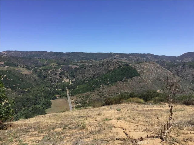 a view of a yard with a wooden fence