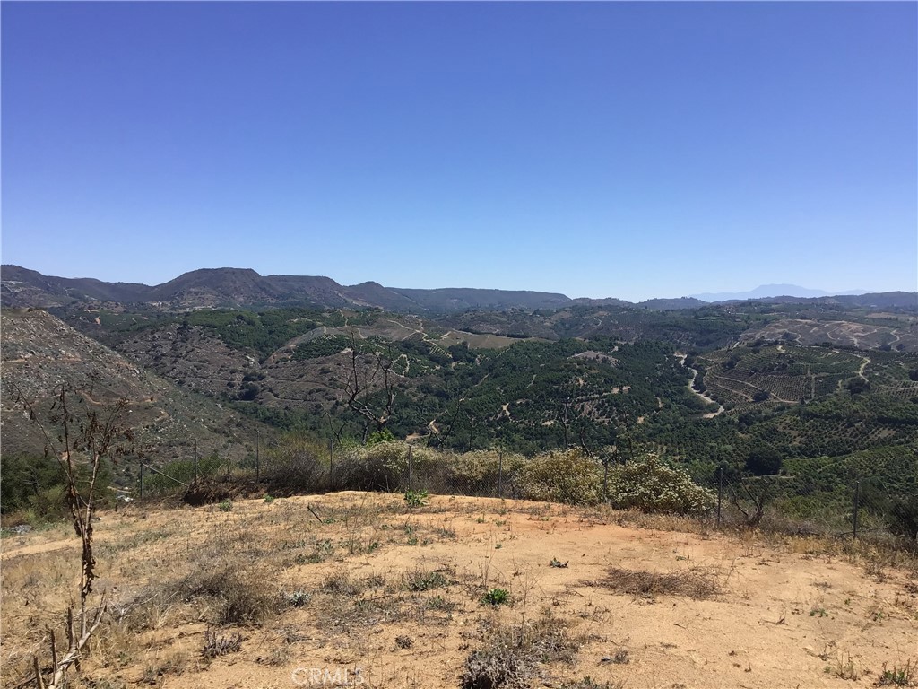 1 Monte Rancho Drive Temecula, CA 92590 - Photo 20 of 66 a view of a yard with a wooden fence