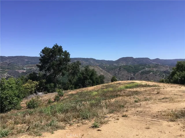 a view of ocean beach and mountain