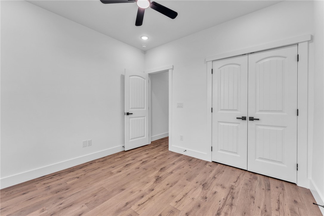1725 Harris Bridge Road Anderson, SC 29621 - Photo 19 of 33 A well-lit bedroom features sturdy hardwood flooring, ample closet space, and a functional ceiling fan.