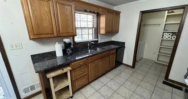 a kitchen with stainless steel appliances granite countertop a sink stove and cabinets