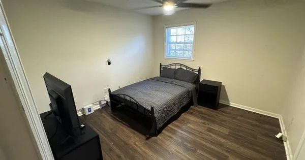a living room with a bed furniture and a window