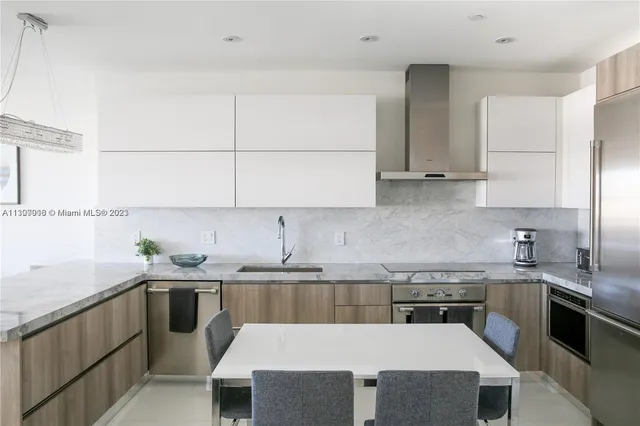 a kitchen with a sink a stove and cabinets