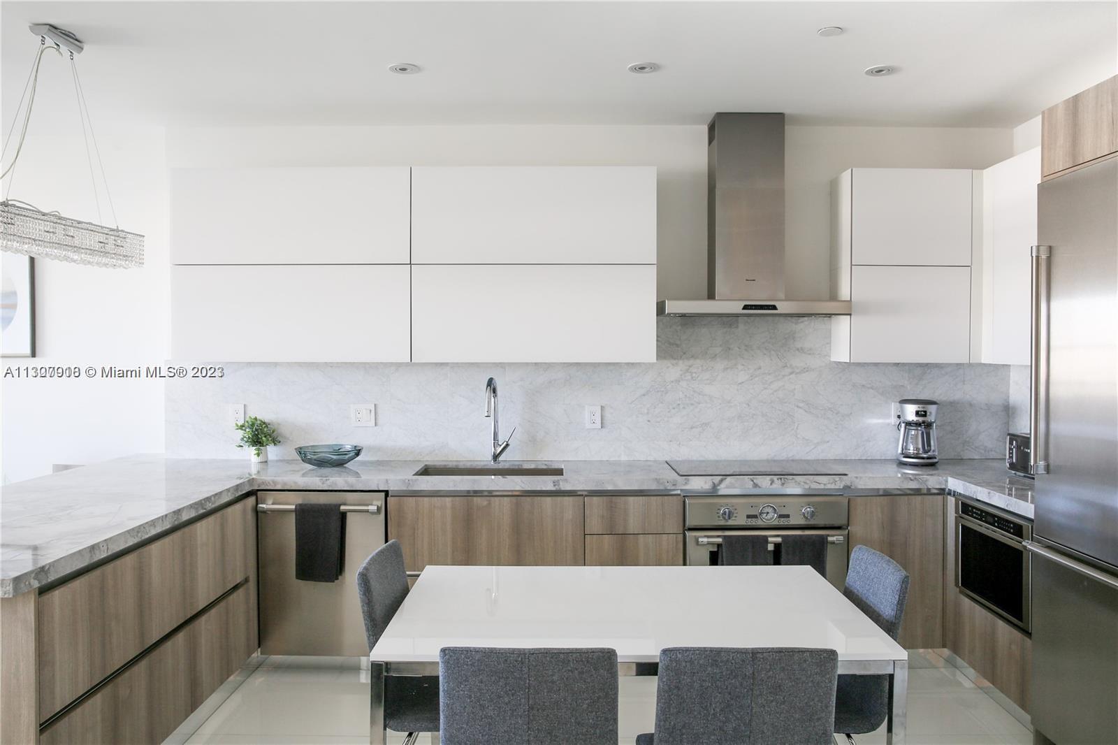 100 Lincoln Road, Unit 1643 Miami Beach, FL 33139 - Photo 3 of 7 a kitchen with a sink a stove and cabinets