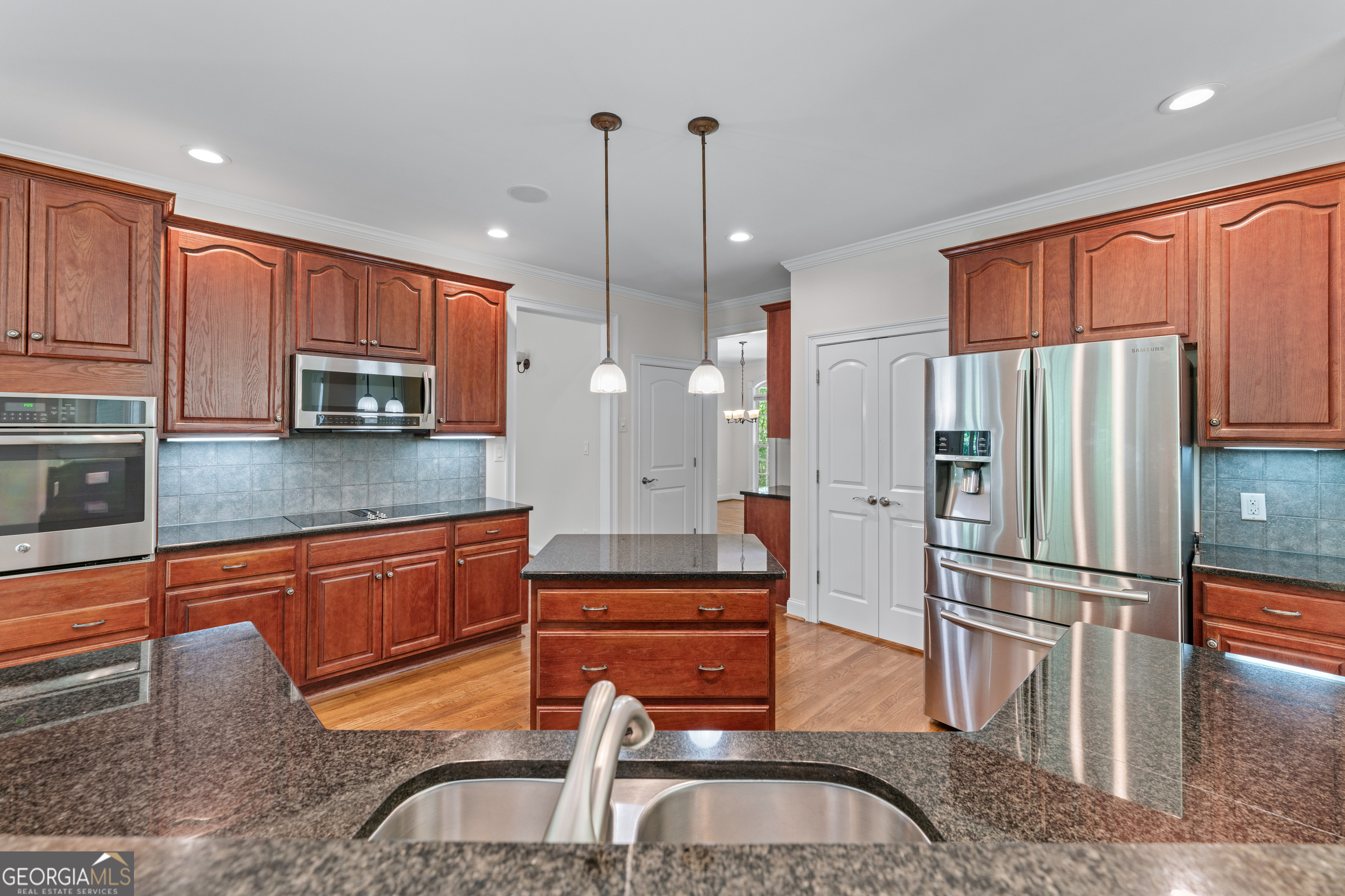6020 Cochran Mill Road Chattahoochee Hills, GA 30213 - Photo 13 of 44 a kitchen with stainless steel appliances granite countertop a refrigerator a stove a sink and a microwave with wooden floor