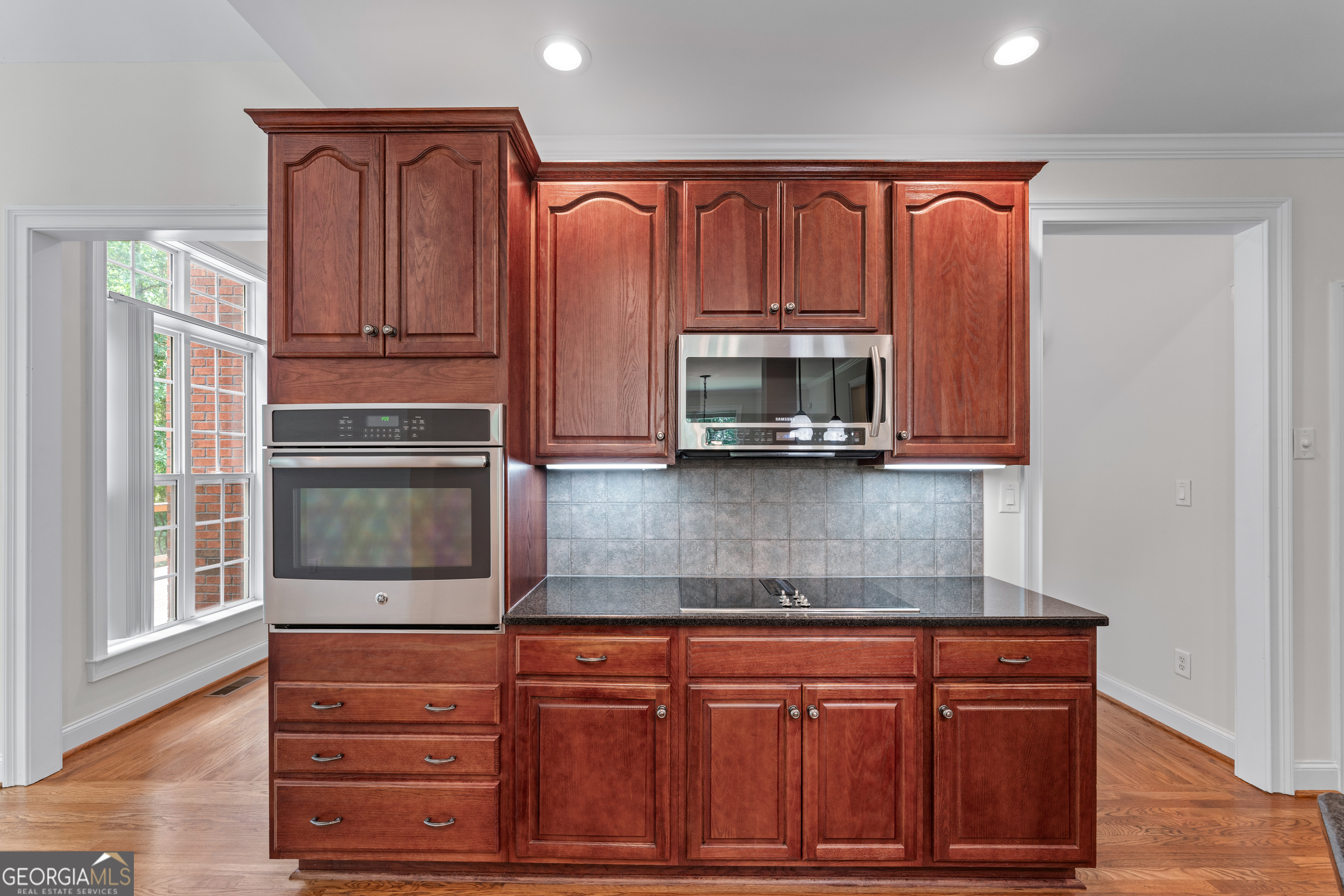 6020 Cochran Mill Road Chattahoochee Hills, GA 30213 - Photo 14 of 44 a kitchen with stainless steel appliances granite countertop a refrigerator and cabinets