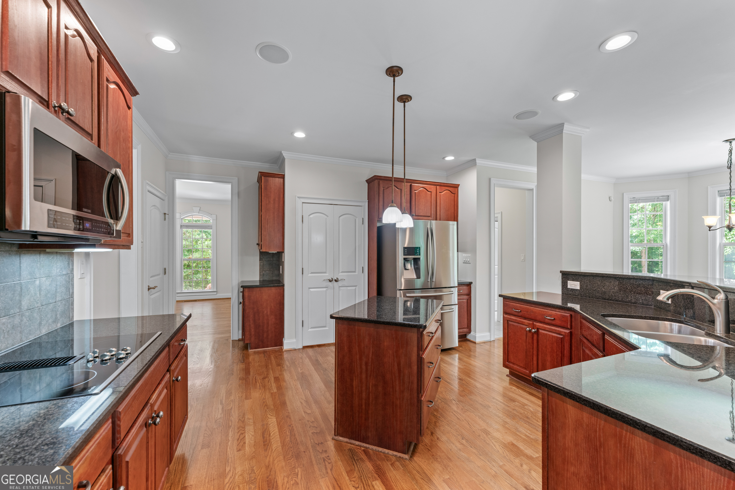 6020 Cochran Mill Road Chattahoochee Hills, GA 30213 - Photo 16 of 44 a kitchen with stainless steel appliances granite countertop a sink a stove and a wooden floors