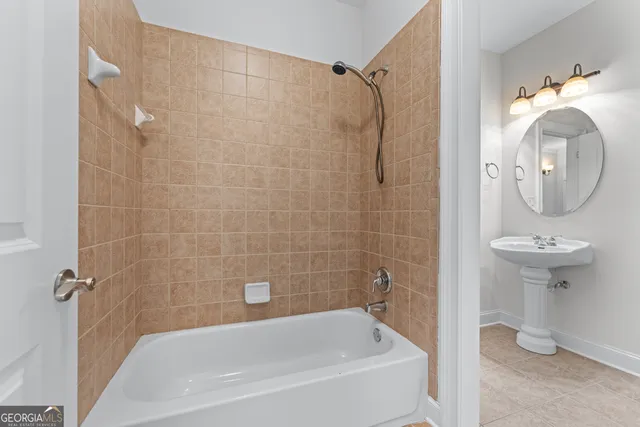 a bathroom with a sink a mirror toilet and bathtub