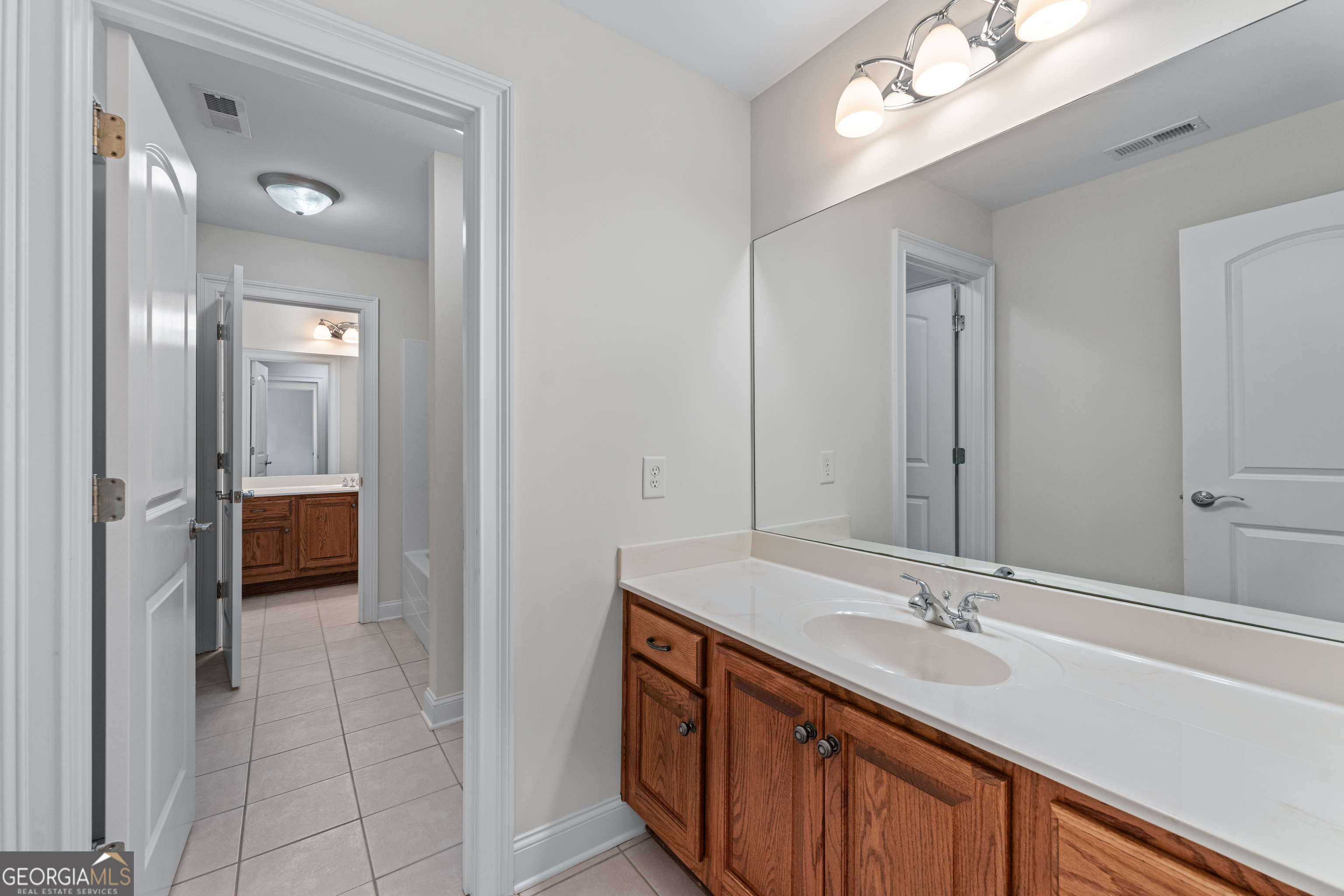 6020 Cochran Mill Road Chattahoochee Hills, GA 30213 - Photo 26 of 44 a en suite bathroom with a double vanity sink and a mirror