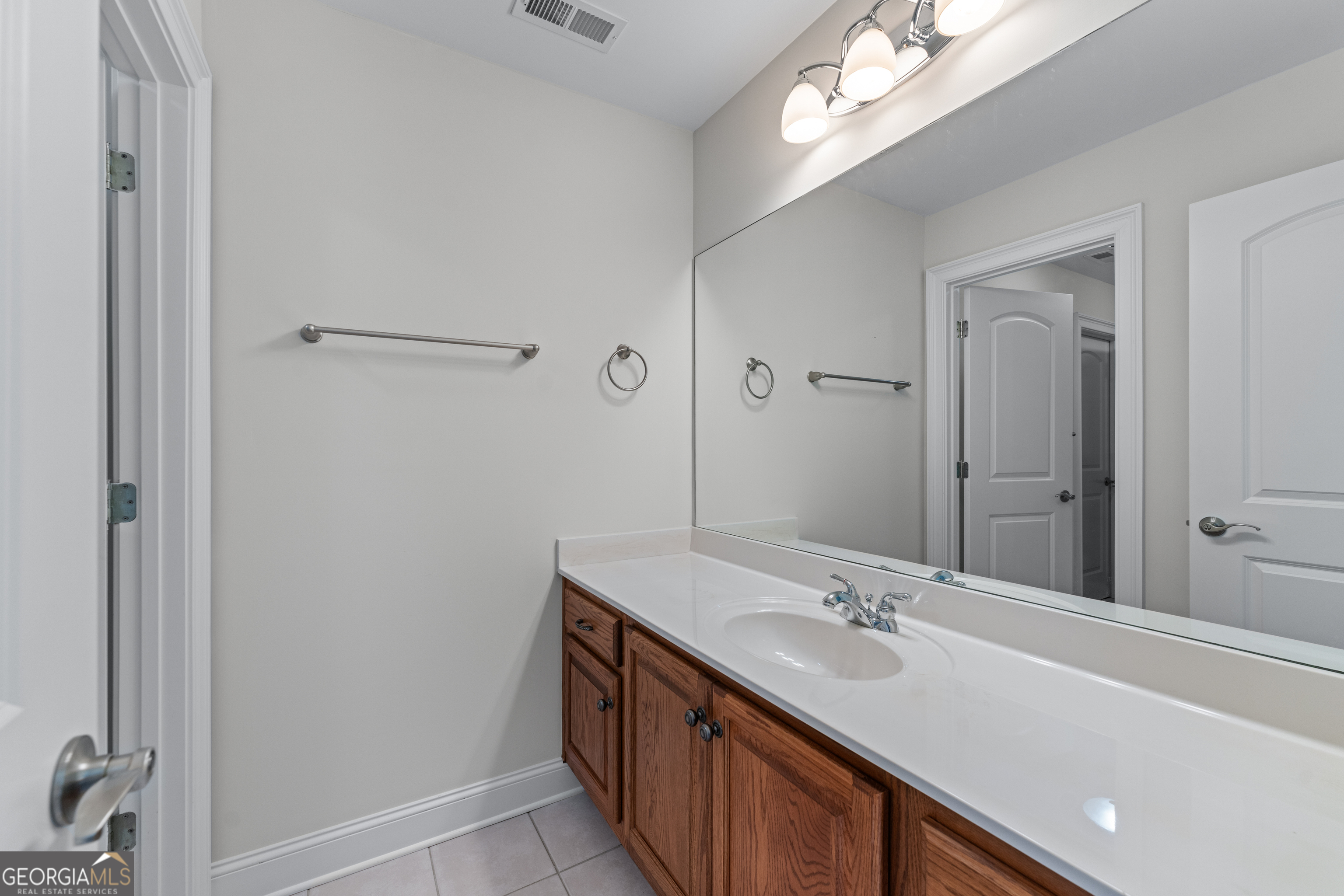 6020 Cochran Mill Road Chattahoochee Hills, GA 30213 - Photo 27 of 44 a bathroom with a sink a mirror and a shower