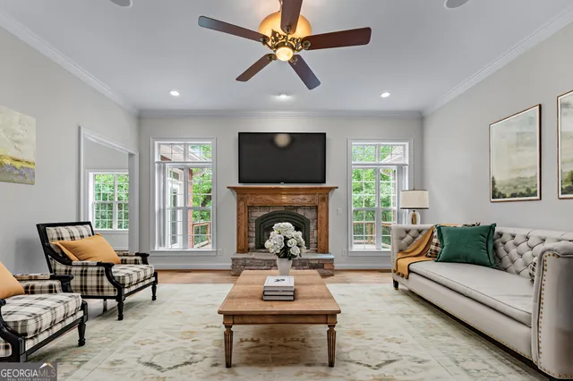a living room with furniture a fireplace and a flat screen tv