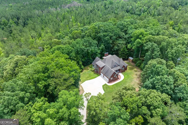 an aerial view of a house with a yard