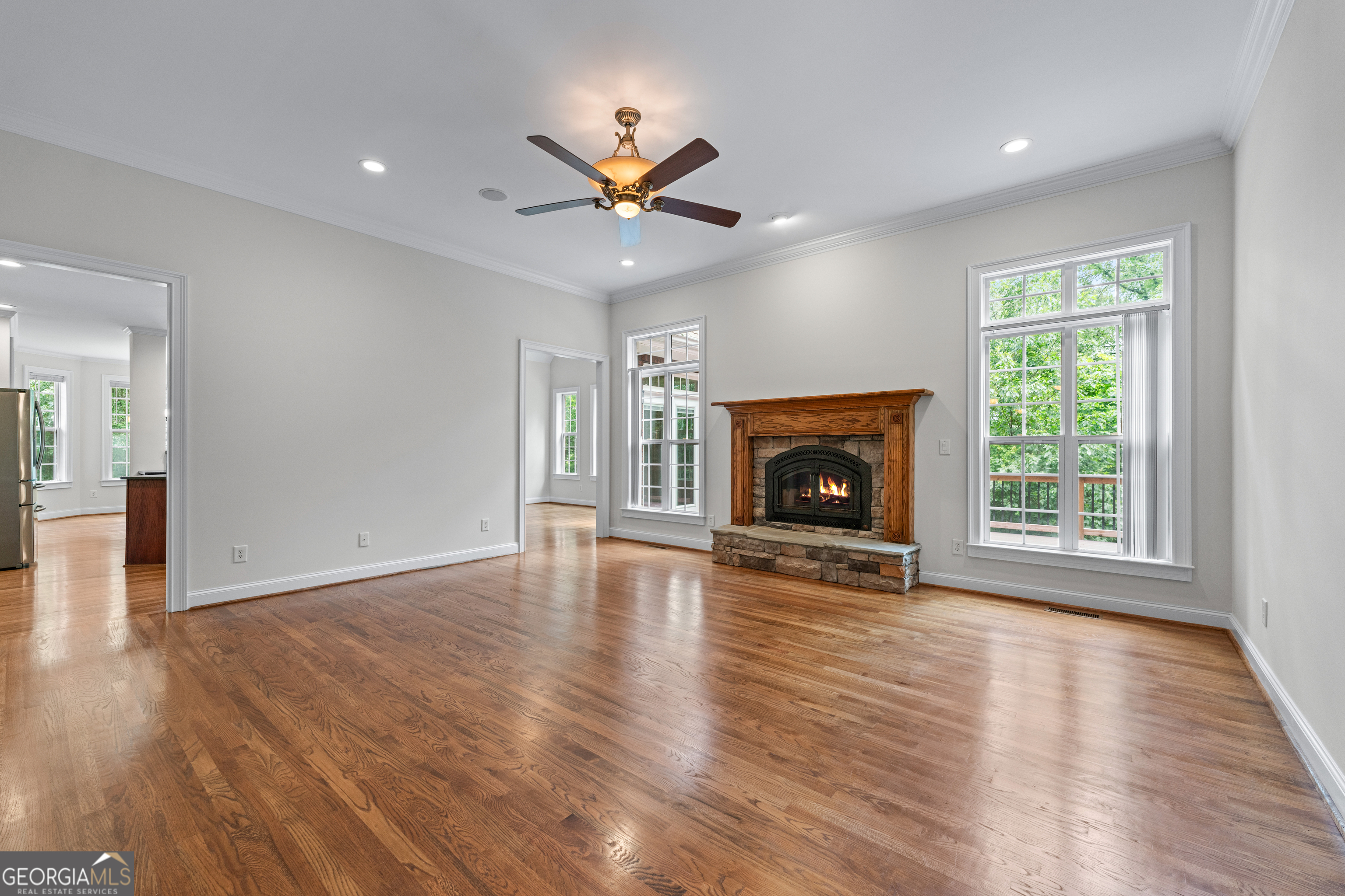 6020 Cochran Mill Road Chattahoochee Hills, GA 30213 - Photo 10 of 44 a view of an empty room with wooden floor fireplace and a window