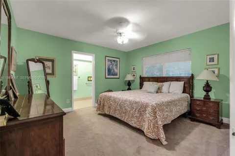 a bedroom with a bed and a mirror