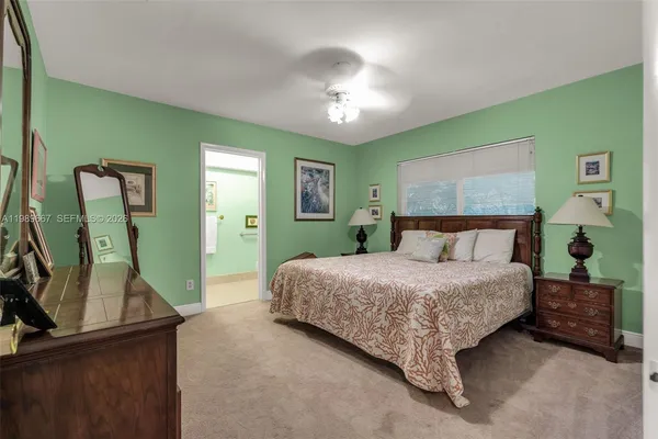 a bedroom with a bed and a mirror
