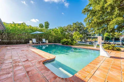 a view of swimming pool with lounge chair