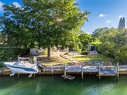 a view of a swimming pool with lawn chairs and a table