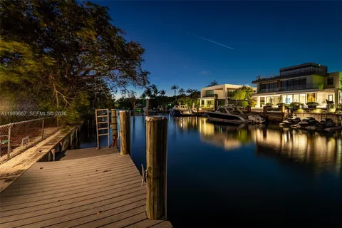 a view of a lake with boats and trees in the background