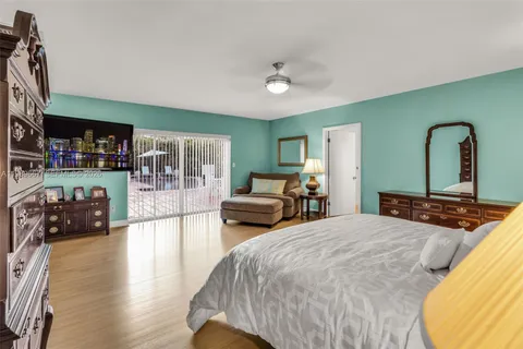 a bedroom with bed and a large mirror