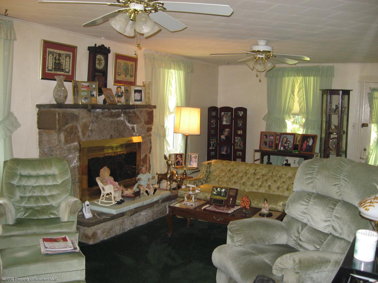 4050 Bear Brook Road Moscow, PA 18444 - Photo 2 of 8 a living room with furniture and a fireplace