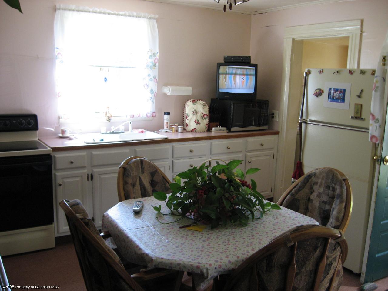4050 Bear Brook Road Moscow, PA 18444 - Photo 3 of 8 a kitchen with a table and chairs in it