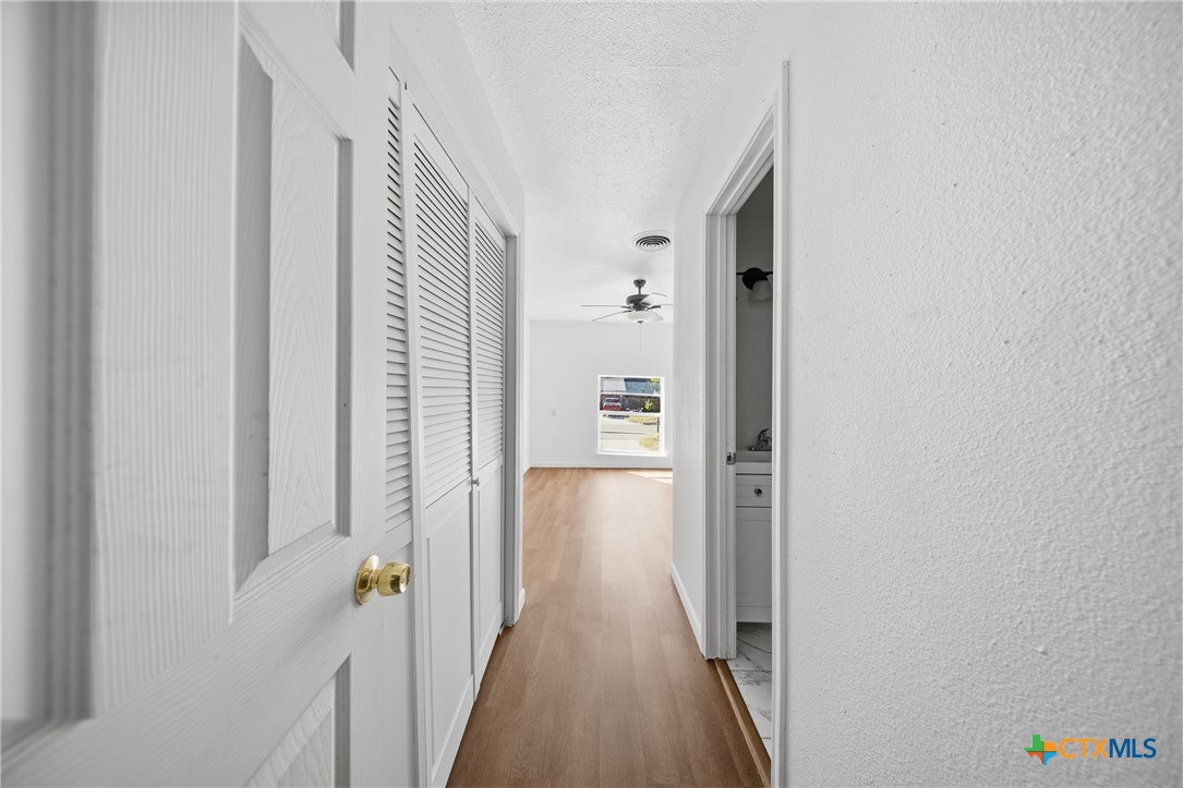 1311 Missouri Avenue Killeen, TX 76541 - Photo 22 of 29 a view of a hallway with wooden floor and staircase