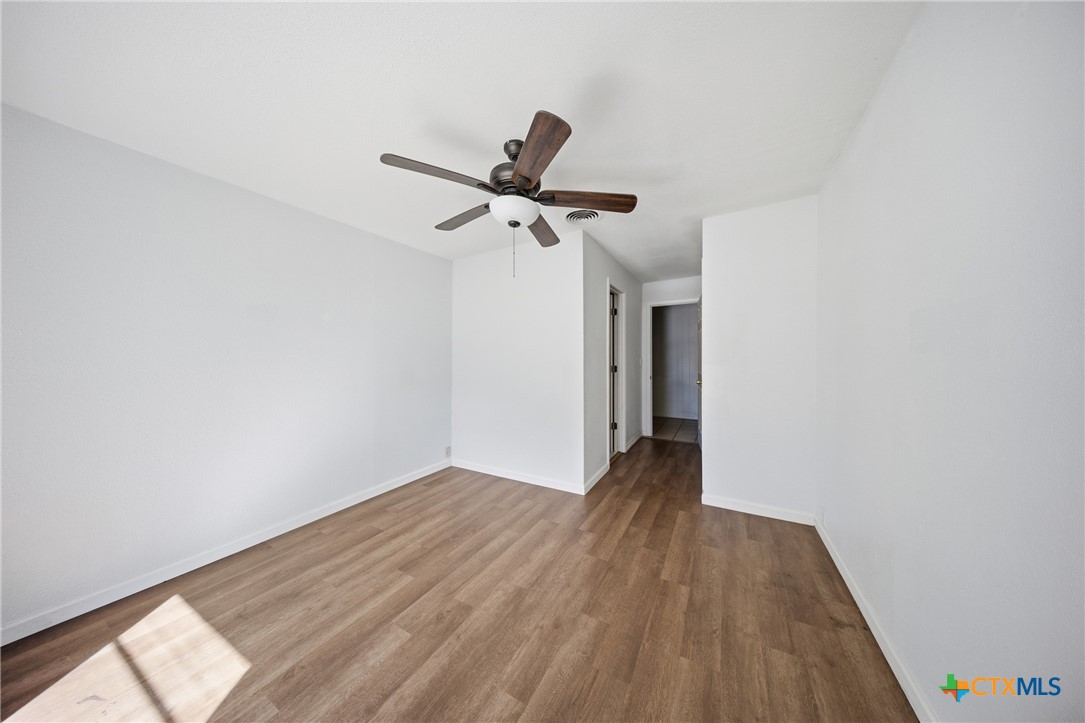 1311 Missouri Avenue Killeen, TX 76541 - Photo 24 of 29 a view of a room with wooden floor ceiling fan