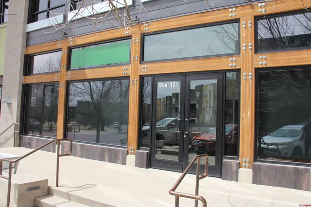 a dining room with a glass door and glass door