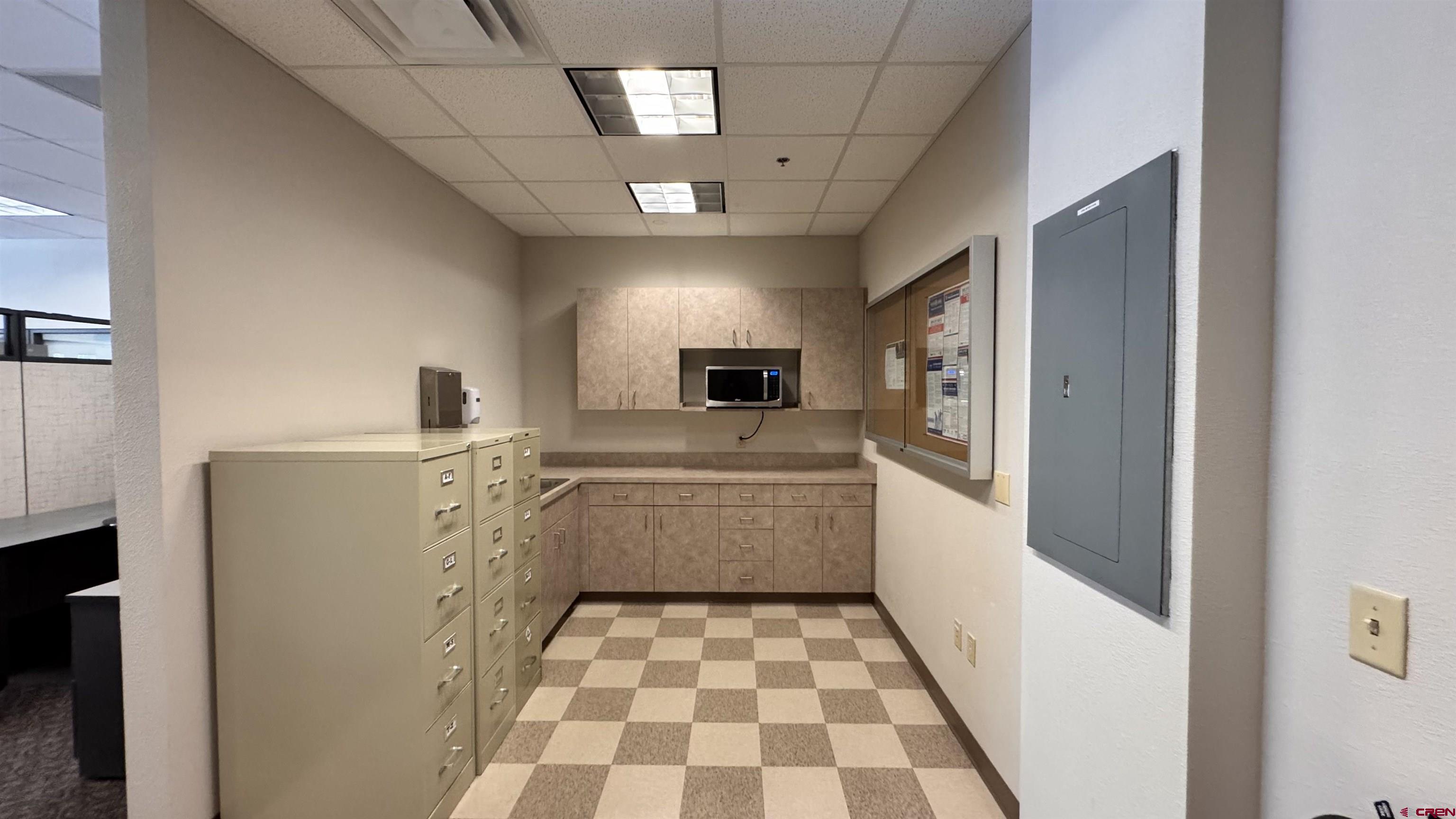 175 Mercado Street, Unit 121 Durango, CO 81301 - Photo 13 of 18 a kitchen with a sink a refrigerator and cabinets