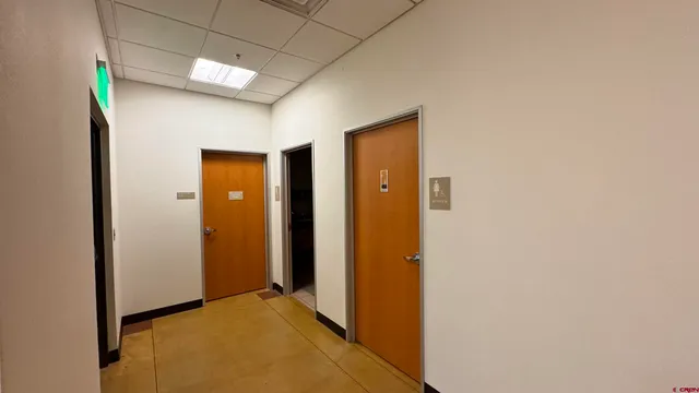 a view of a hallway with wooden shelves
