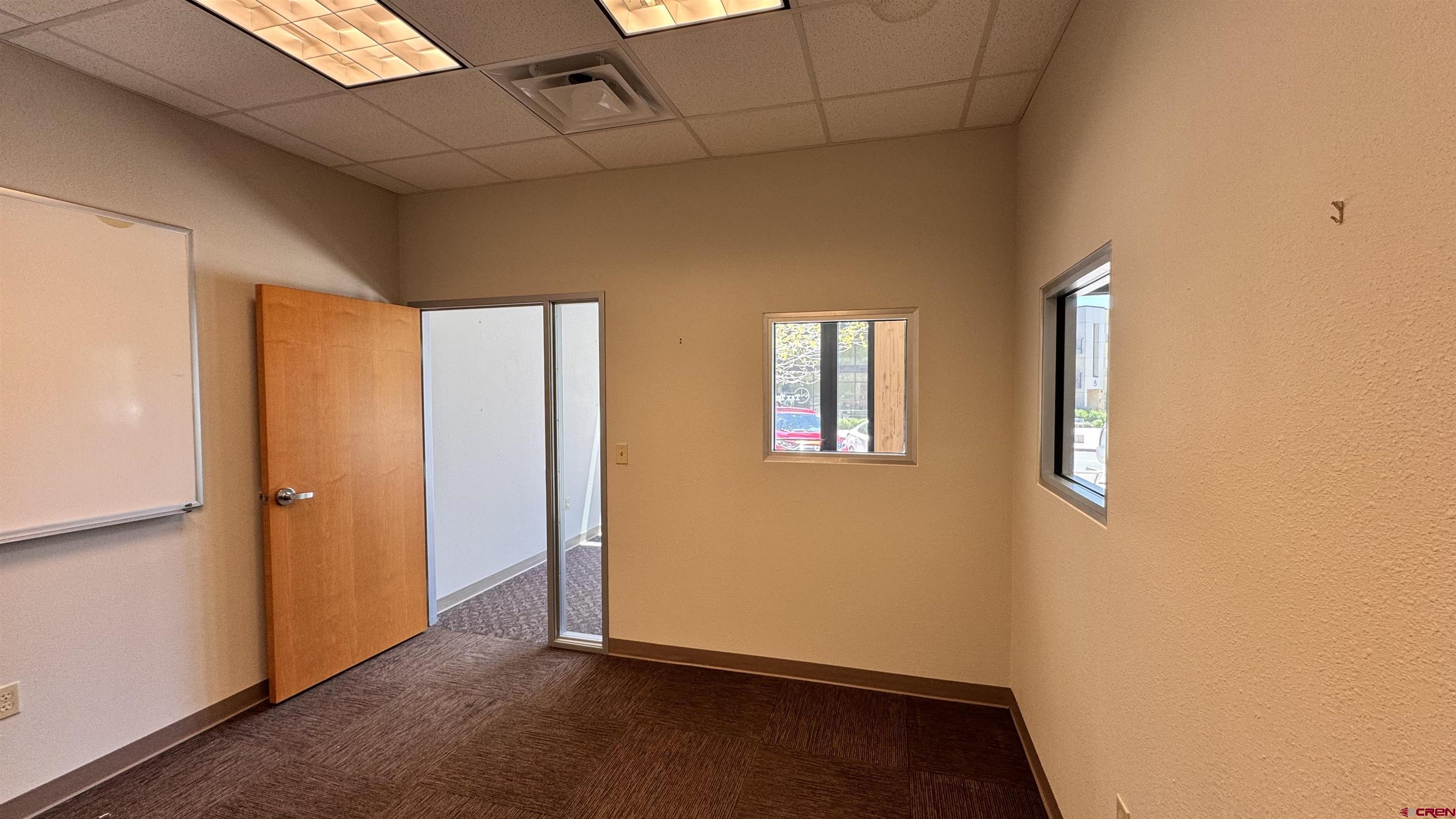 175 Mercado Street, Unit 121 Durango, CO 81301 - Photo 7 of 18 an empty room with windows