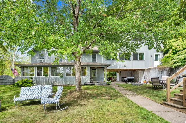 a front view of a house with a yard table and chairs