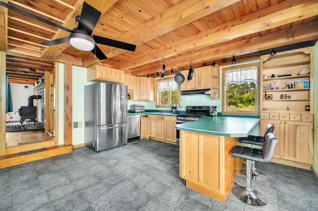 a kitchen with stainless steel appliances granite countertop a refrigerator and a stove