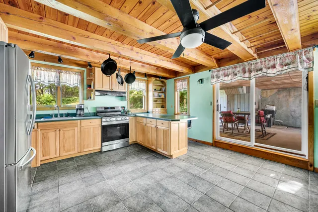 a open kitchen with stainless steel appliances granite countertop a stove a sink and a refrigerator