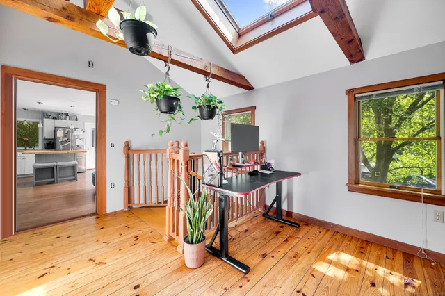a view of a workspace with wooden floor