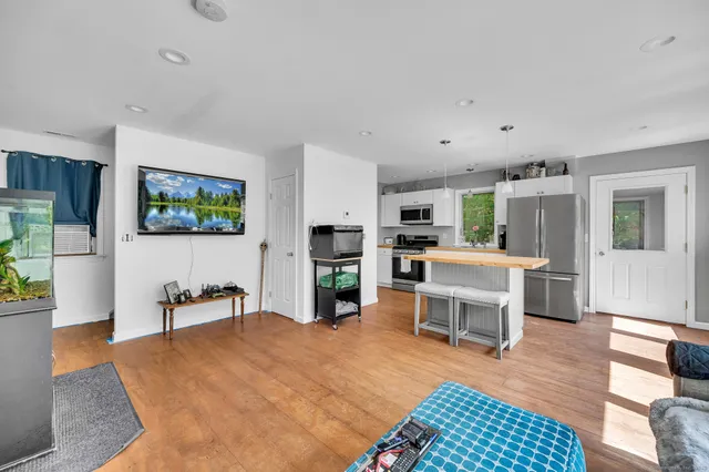 a living room with furniture and a kitchen view
