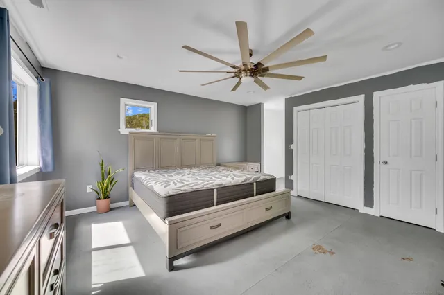 a living room with a bed furniture and a window