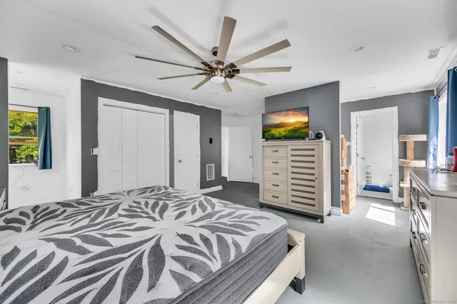 a bedroom with a bed and a television