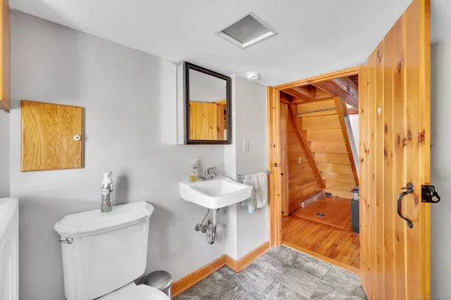 a bathroom with a sink mirror and tub