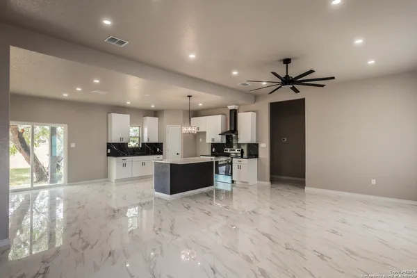 a view of kitchen with refrigerator and window
