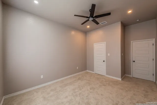 an empty room with a ceiling fan and a ceiling fan