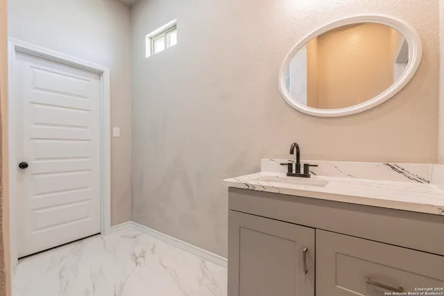 a bathroom with a sink and a mirror