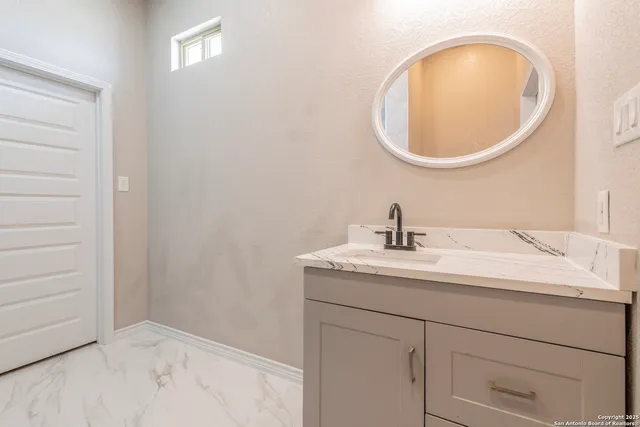 a bathroom with a sink and a mirror