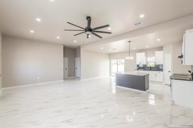 a view of a kitchen and kitchen with stainless steel appliances wooden floor