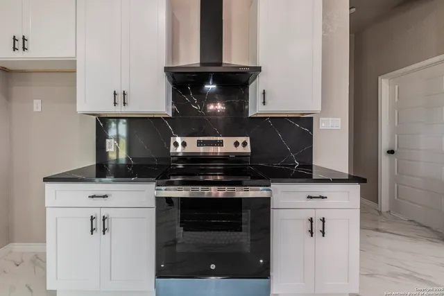 a stove top oven sitting inside of a kitchen