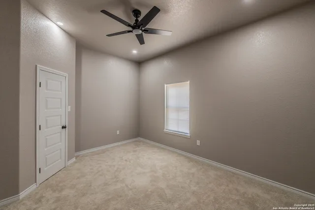 an empty room with a empty space and a ceiling fan