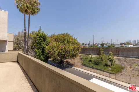 a view of a terrace with a garden and potted plants