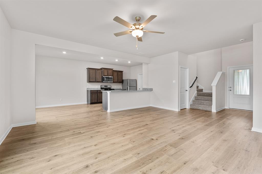 209 Southgate Drive Terrell, TX 75160 - Photo 2 of 5 a view of an empty room with wooden floor and a ceiling fan