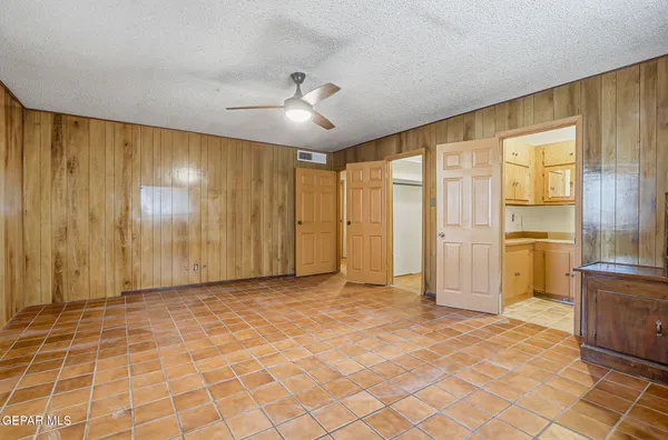 a view of a livingroom with a chandelier furniture and large window